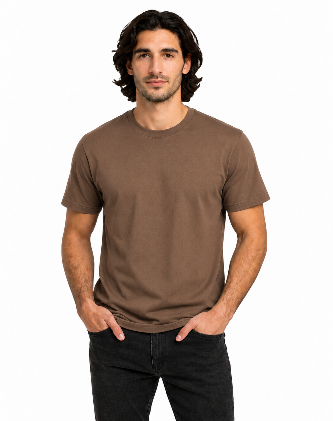 A man with dark hair modeling a plain brown short-sleeve crewneck t-shirt and black jeans against a solid white background.