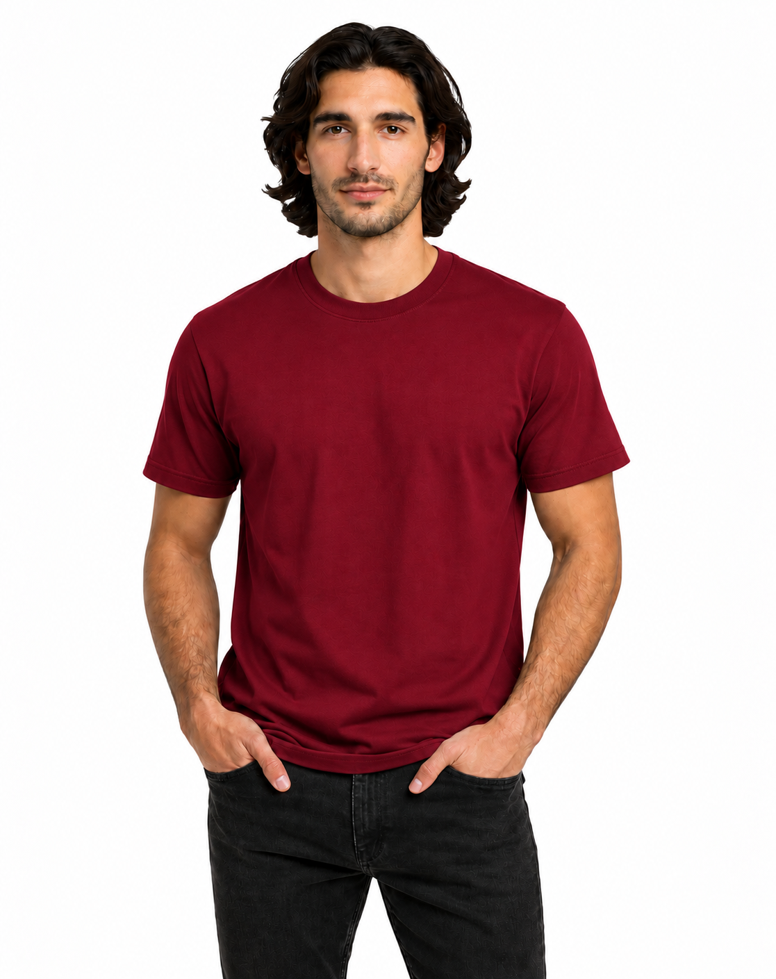 A man wearing a solid maroon crewneck t-shirt and black jeans, standing against a plain white background.