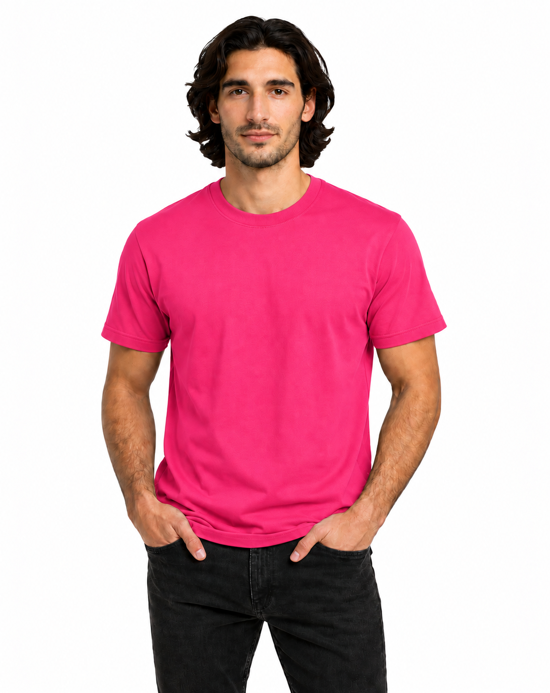 A man wearing a bright pink crew-neck t-shirt and black jeans, standing against a plain white background.