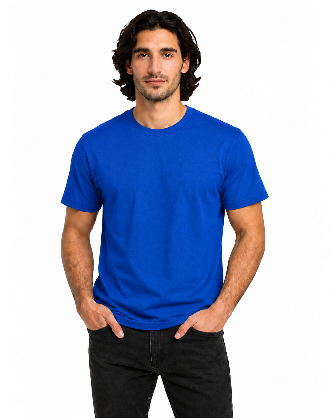 A man wearing a solid royal blue crewneck t-shirt and black jeans, standing against a plain white background.