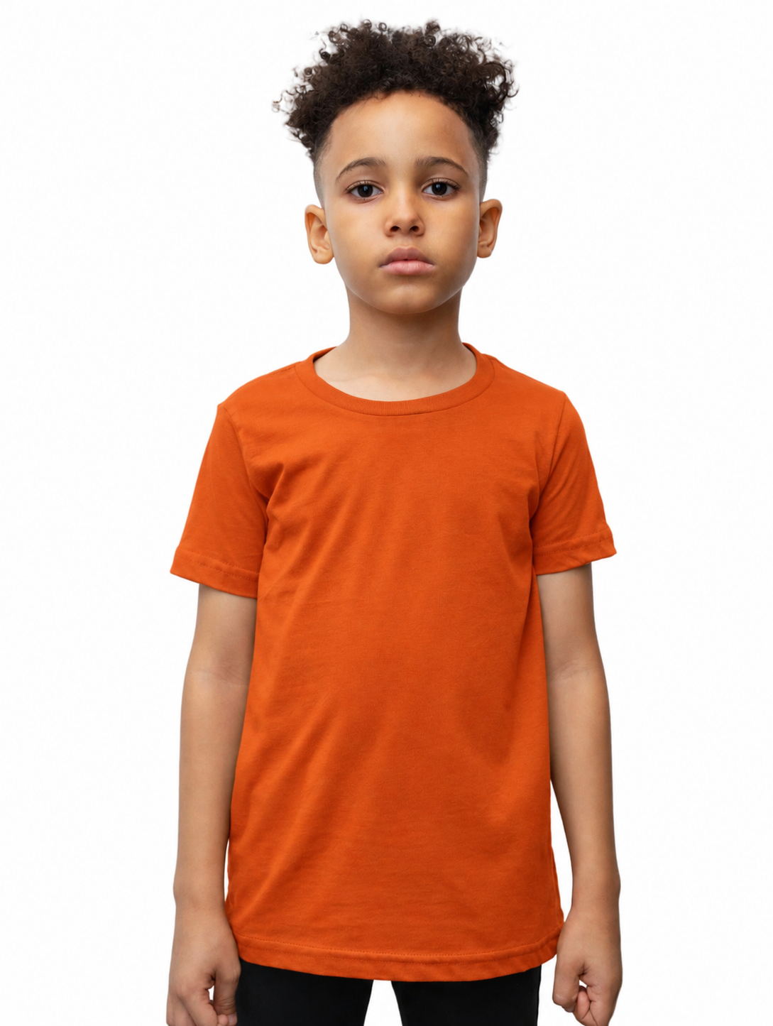 A young boy with curly dark hair wearing a solid orange short-sleeve crewneck t-shirt, standing against a plain white background.