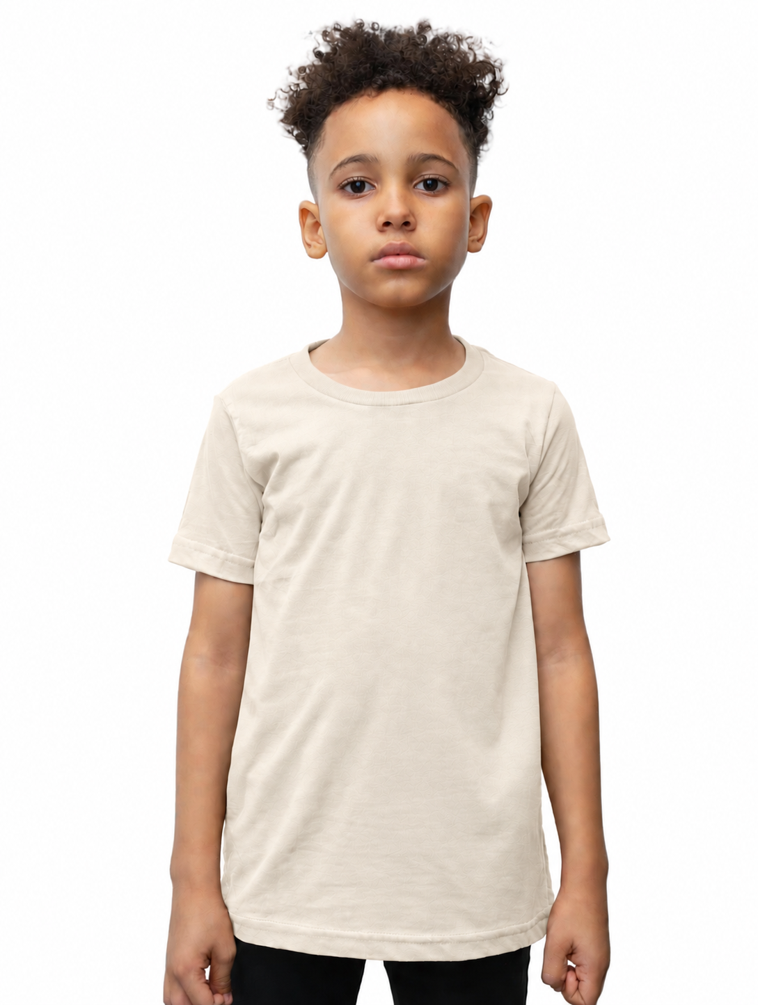 A child model wearing a plain, short-sleeve crewneck t-shirt in a light cream or off-white color, paired with black pants, shot against a solid white background.