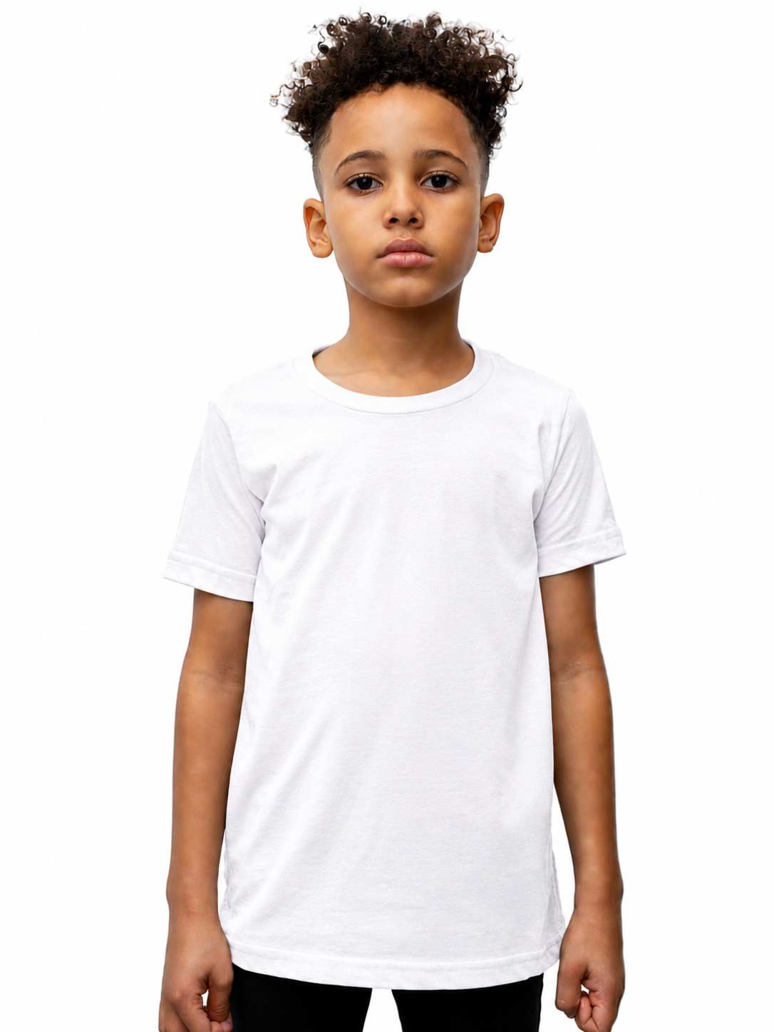 A young boy with curly dark hair wearing a plain white short-sleeve crewneck t-shirt, standing against a solid white background.