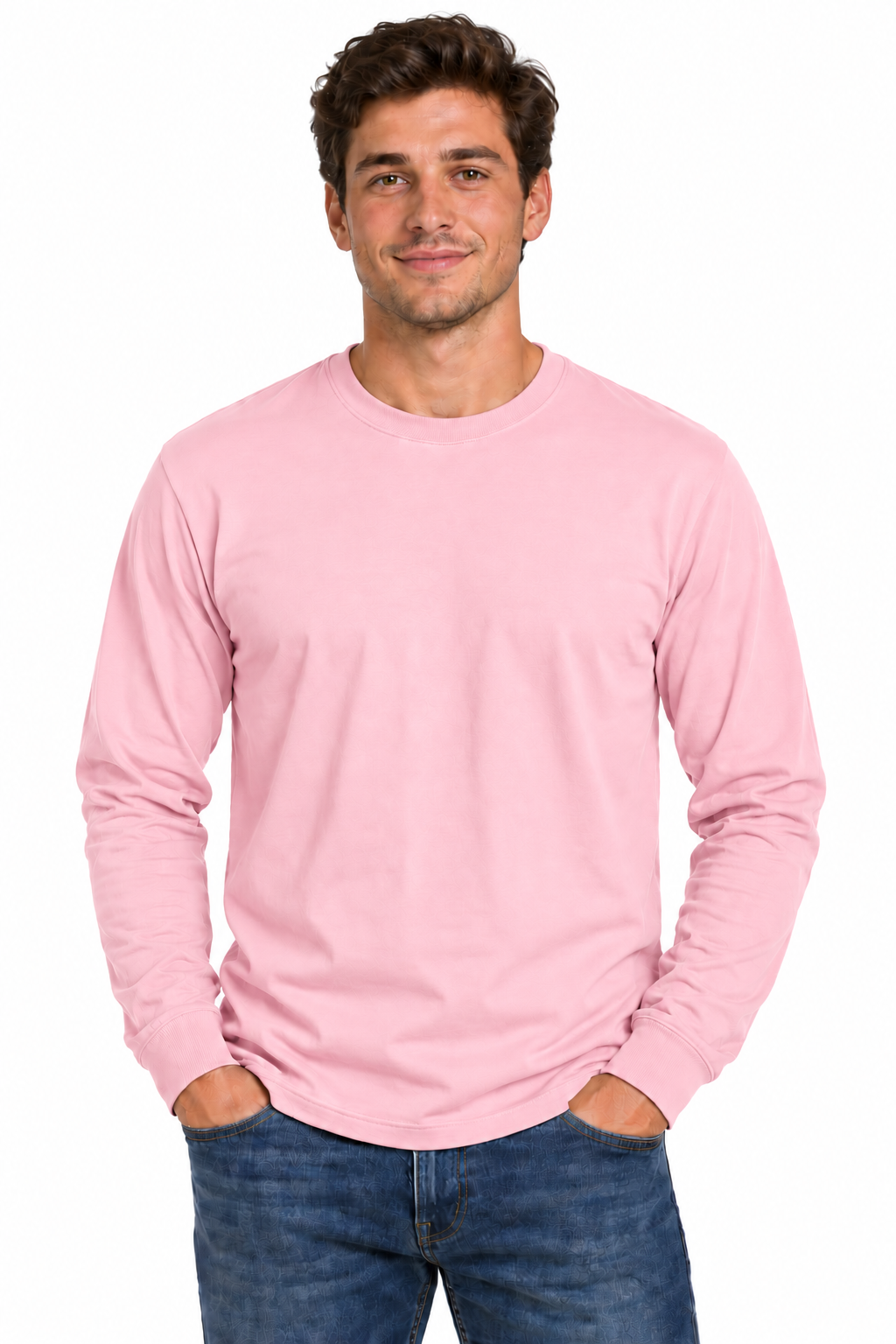 A man wearing a light pink long-sleeve crewneck t-shirt and blue jeans, standing against a plain white background.