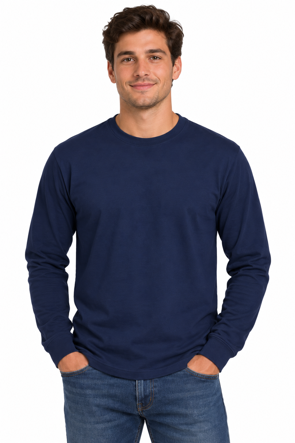 A man wearing a solid navy blue long-sleeve crewneck t-shirt and blue jeans, standing against a plain white background.