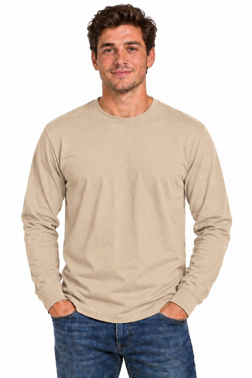 A man wearing a beige long-sleeve crewneck t-shirt and blue jeans, standing against a plain white background.