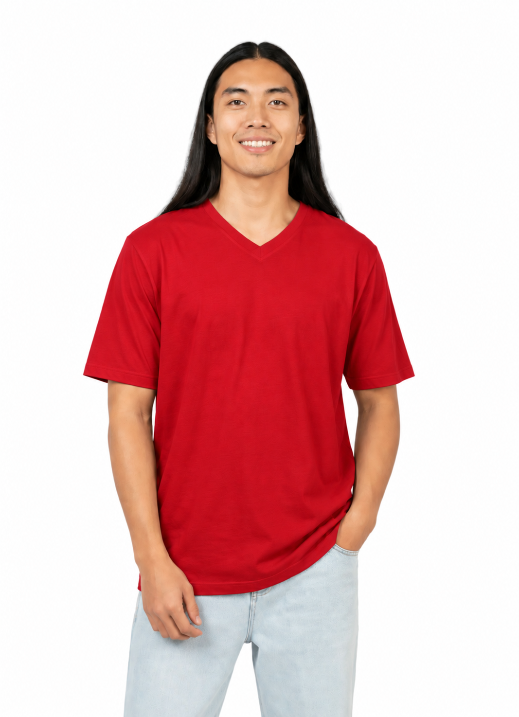 A man with long black hair wearing a solid red short-sleeve v-neck t-shirt and light blue jeans, standing against a plain white background.