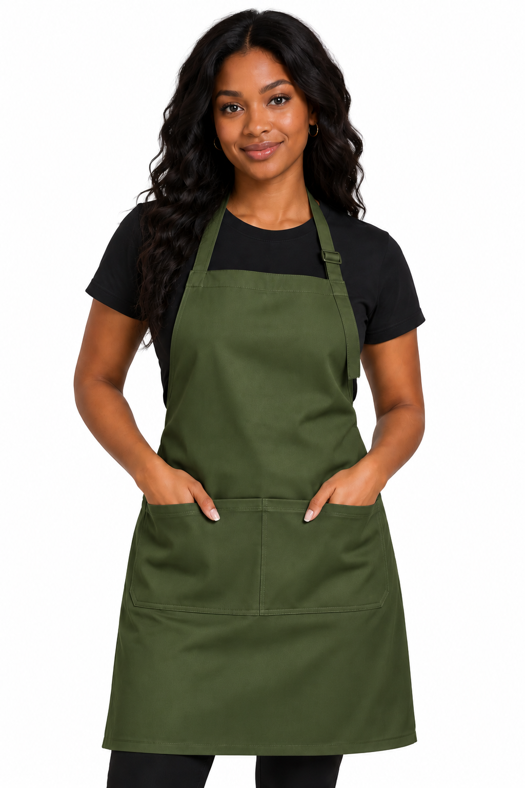 A woman modeling an olive green bib apron with two front pockets over a black t-shirt, against a plain white background.