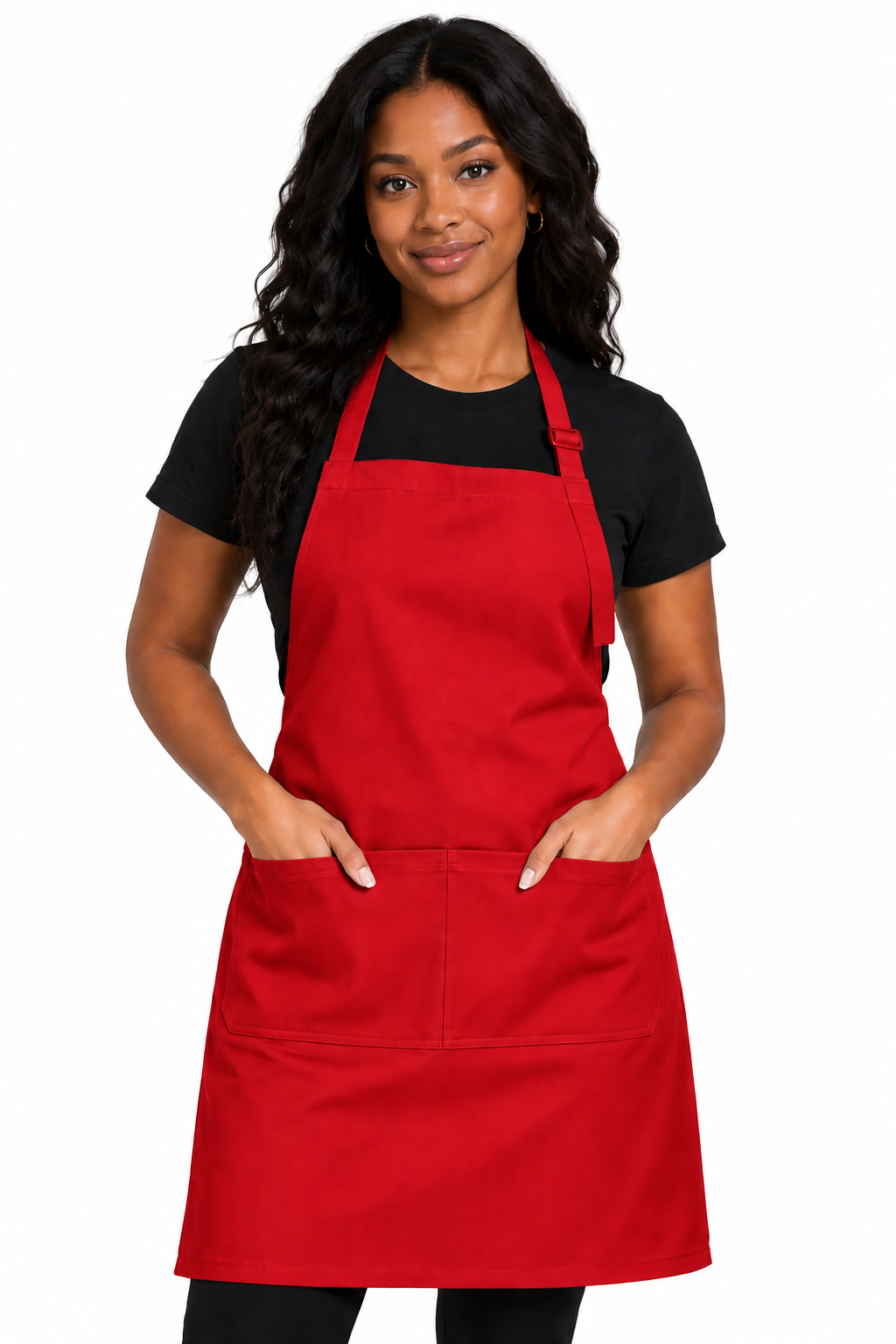 A woman modeling a bright red bib apron with two front pockets over a black t-shirt, photographed against a solid white background.