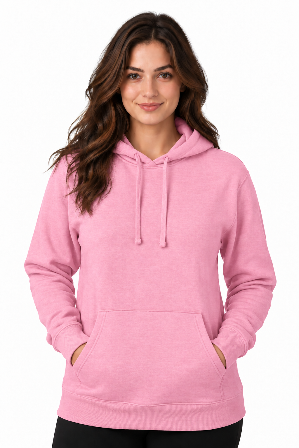 A woman wearing a light pink pullover hoodie with drawstrings and a front kangaroo pocket, standing against a plain white studio background.