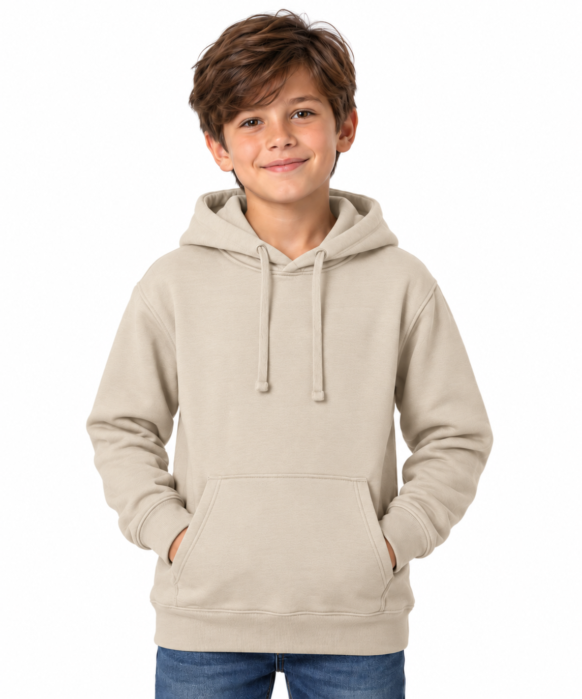 A young boy with brown hair modeling a light beige pullover hoodie with drawstrings and a front kangaroo pocket, paired with blue jeans, against a solid white background.