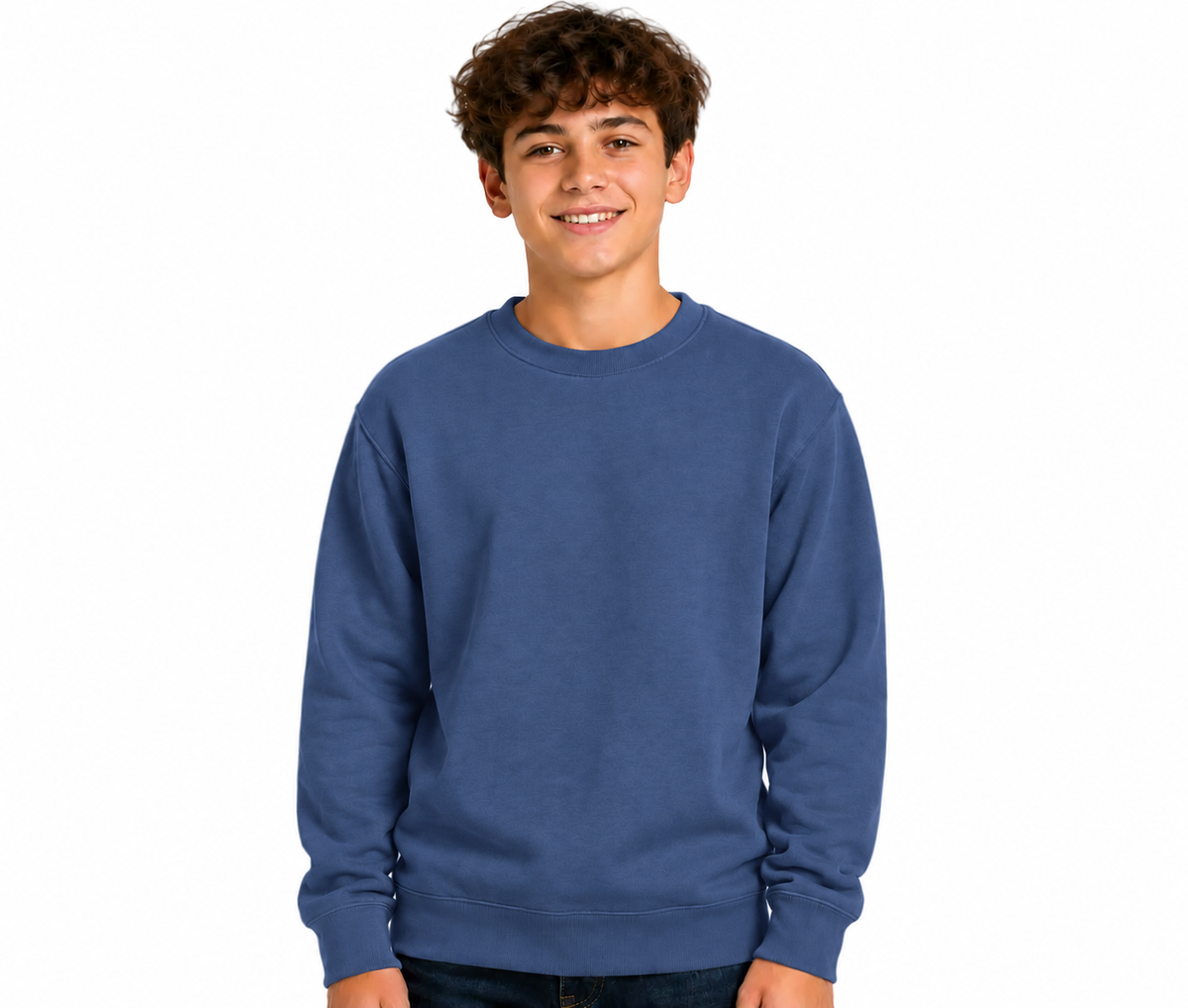 A smiling young man with curly brown hair wearing a solid medium blue crewneck sweatshirt, photographed against a clean white background.