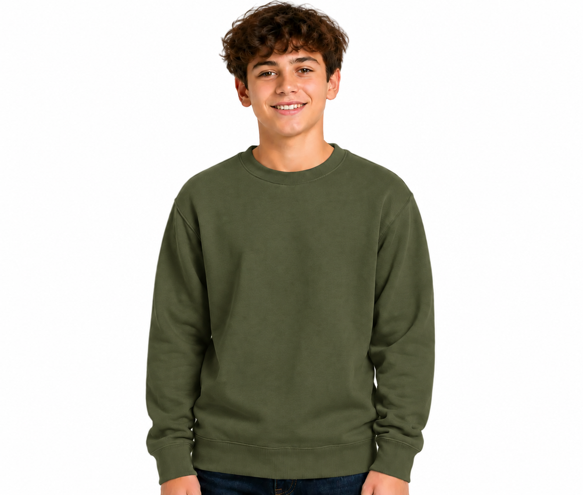 A smiling young man with curly brown hair wearing an olive green crewneck sweatshirt and dark blue jeans, standing against a solid white background.