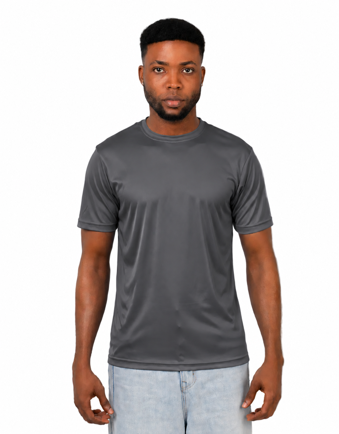 A man wearing a dark gray short-sleeve crewneck athletic t-shirt and light wash jeans, standing against a solid white background.