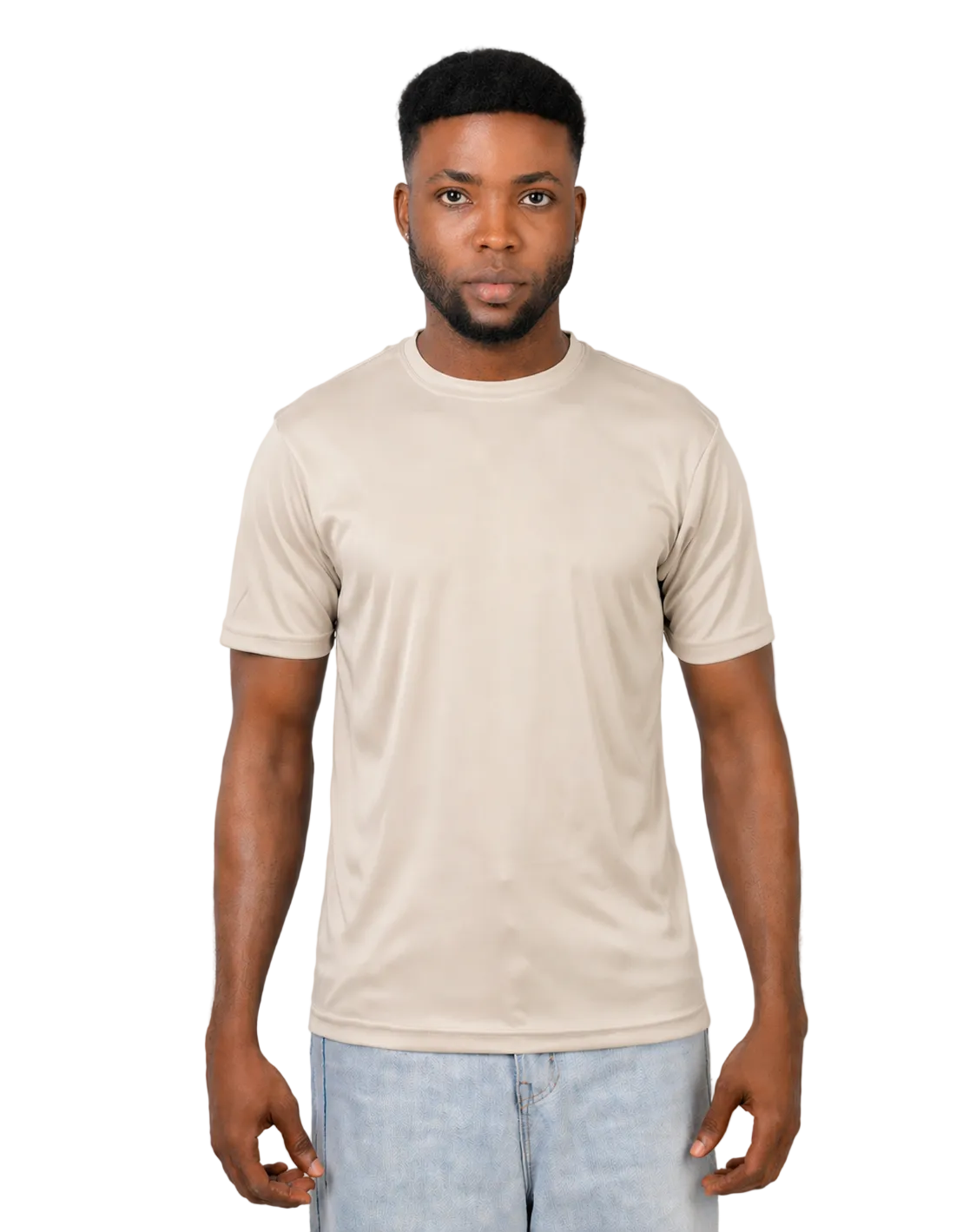 Man wearing a beige t-shirt and light blue jeans against a plain background