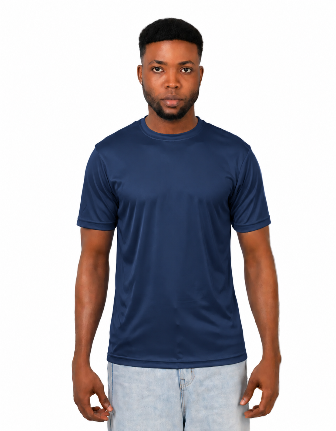 A man wearing a solid navy blue short-sleeve crewneck t-shirt and light wash jeans, standing against a plain white background.