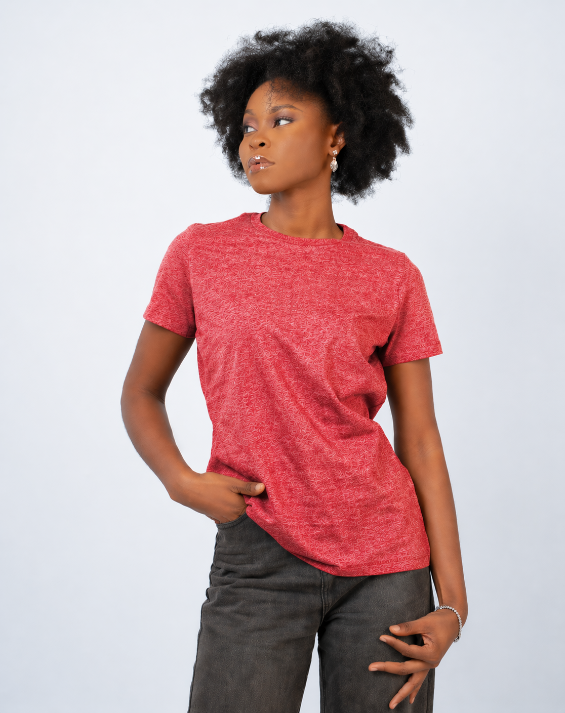 Person wearing a red t-shirt and gray pants on a white background