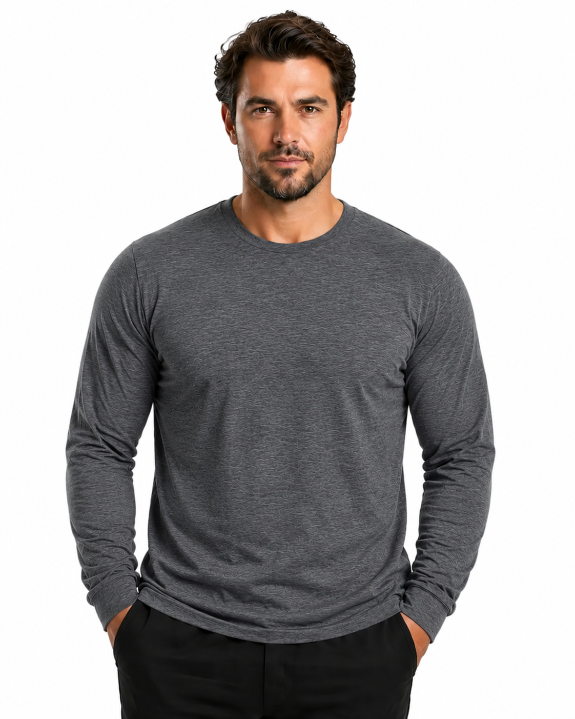 A man wearing a dark heather gray long-sleeve crewneck shirt and black pants, standing against a solid white background.