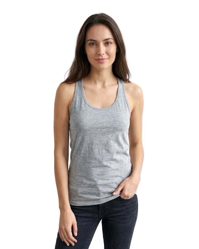 Woman wearing a gray tank top and dark jeans against a white background