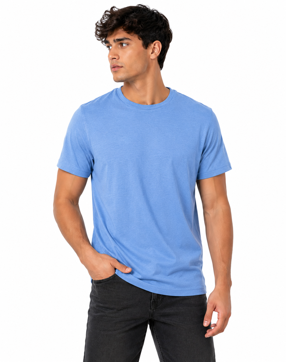 A man wearing a light blue crew-neck t-shirt and dark gray jeans, standing against a plain white background.