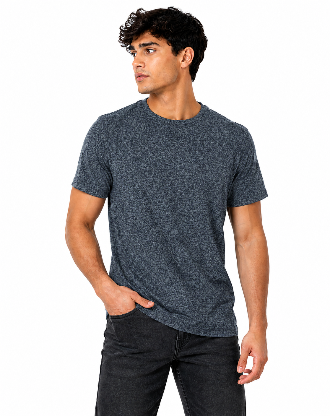 A man wearing a dark heather gray crewneck t-shirt and dark jeans, standing against a solid white background.