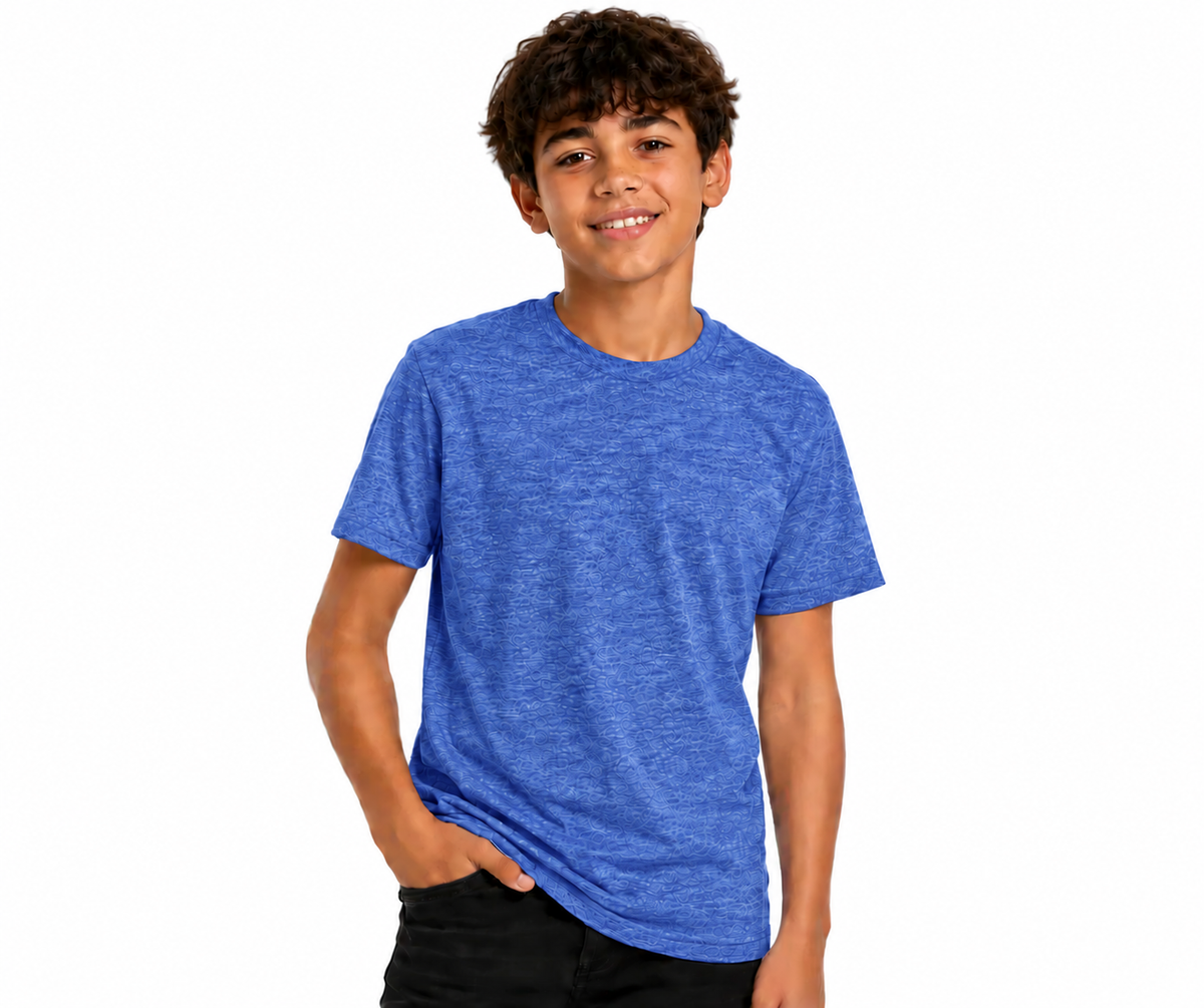 A young boy with curly brown hair wearing a heathered blue crewneck t-shirt and black pants, standing against a solid white background.