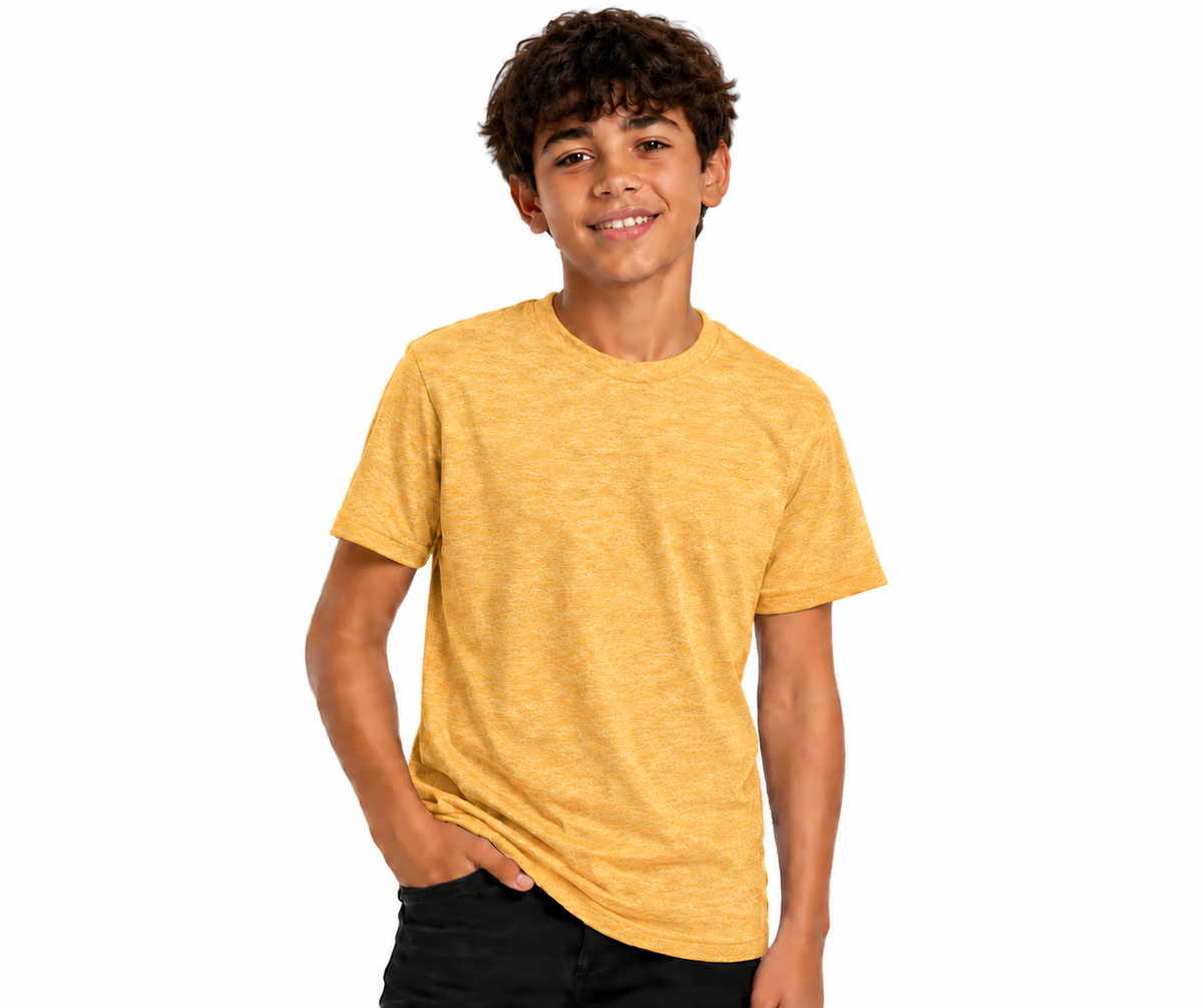 A young boy with curly brown hair smiling, wearing a heathered mustard yellow short-sleeve crewneck t-shirt and black pants, photographed against a solid white background.